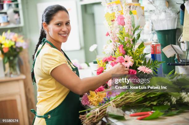 hispanic woman working in florist shop - florist arranging stock pictures, royalty-free photos & images