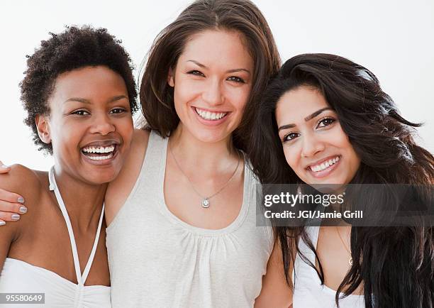 smiling friends hugging - beautiful woman white background stock pictures, royalty-free photos & images