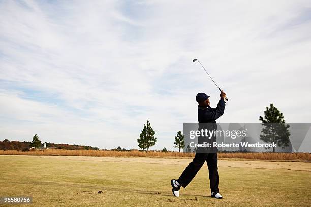 african boy swinging golf club - golfer swing stock pictures, royalty-free photos & images