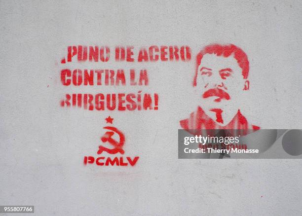 Graffiti with "Iron hand against Middle-class graffiti" and a portrait of Joseph Vissarionovich Stalin is seen on a public wall.