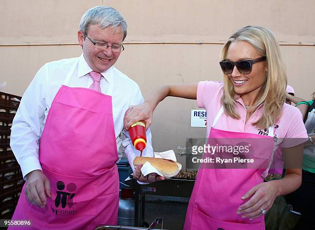 Australian Prime Minister Kevin Rudd and televsion presenter Lee Furlong serve sausages in support of the McGrath Foundation before day three of the...