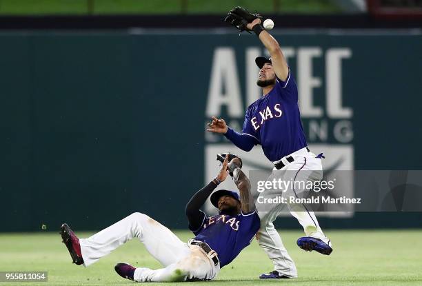 Isiah Kiner-Falefa of the Texas Rangers drops the ball as Delino DeShields slides underneath in the eighth inning at Globe Life Park in Arlington on...