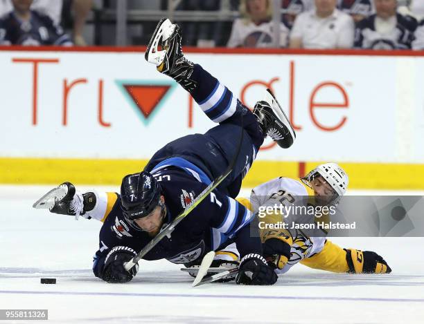 Ben Chiarot of the Winnipeg Jets collides with Kevin Fiala of the Nashville Predators in Game Six of the Western Conference Second Round during the...