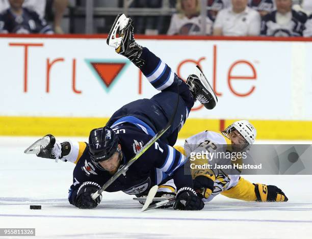 Ben Chiarot of the Winnipeg Jets collides with Kevin Fiala of the Nashville Predators in Game Six of the Western Conference Second Round during the...