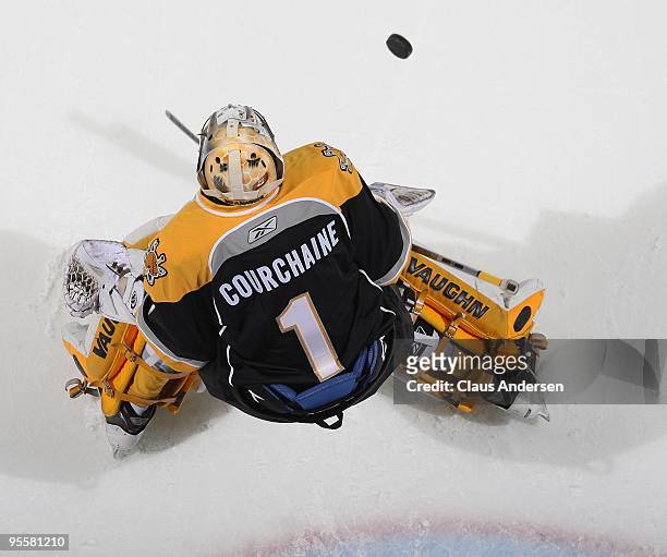 Adam Courchaine of the Sarnia Sting stops a shot in the pre-game warm-up prior to a game against the London Knights on December 31, 2009 at the John...
