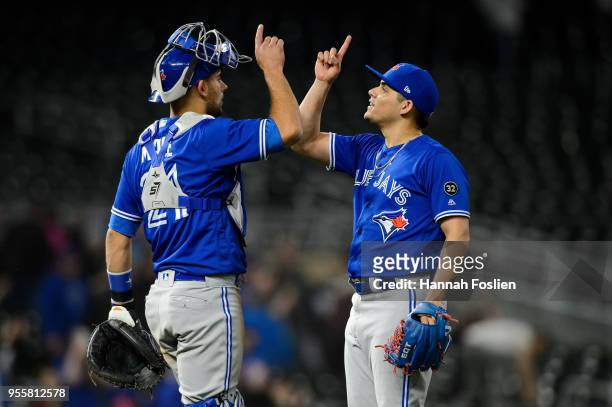 Luke Maile and Roberto Osuna of the Toronto Blue Jays celebrate winning against the Minnesota Twins after the game on May 1, 2018 at Target Field in...