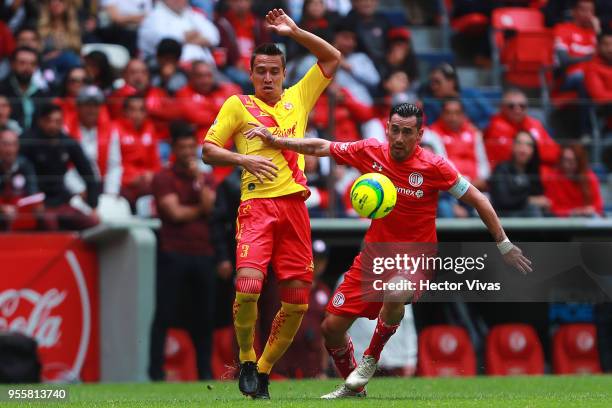 Carlos Rodriguez of Morelia struggles for the ball with Rubens Sambueza of Toluca during the quarter finals second leg match between Toluca and...