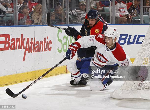 Max Pacioretty of the Montreal Canadiens and Stephen Weiss of the Florida Panthers skate after the puck on December 31, 2009 at the BankAtlantic...