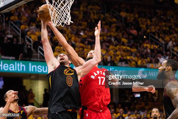 Kevin Love of the Cleveland Cavaliers fights for a rebound with Jonas Valanciunas of the Toronto Raptors during the second half of Game 4 of the...