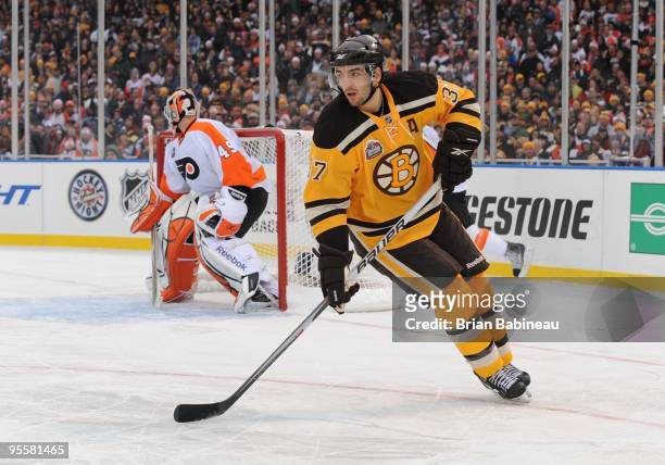 Patrice Bergeron of the Boston Bruins skates up the ice against the Philadelphia Flyers in the 2010 Bridgestone Winter Classic at Fenway Park on...