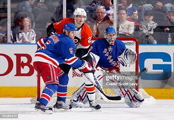 Goaltender Chad Johnson and defensemen Dan Girardi of the New York Rangers protect the net against James Van Riemsdyk of the Philadelphia Flyers on...