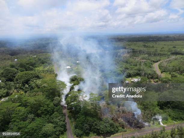 Smoke rises from forest as dozens of structures, including at least nine homes, have been destroyed by scorching lava flows following a massive...