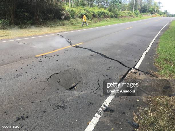 Collapsed road is seen as dozens of structures, including at least nine homes, have been destroyed by scorching lava flows following a massive...