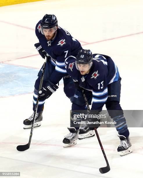 Ben Chiarot and Brandon Tanev of the Winnipeg Jets get set for a second period face-off against the Nashville Predators in Game Six of the Western...