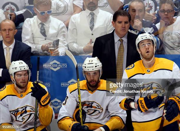 Head Coach Peter Laviolette of the Nashville Predators looks on from the bench during second period action against the Winnipeg Jets in Game Six of...