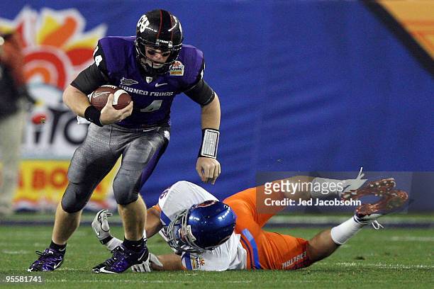Quarterback Andy Dalton of the TCU Horned Frogs runs the ball past Aaron Tevis of the Boise State Broncos in the first quarter during the Tostitos...