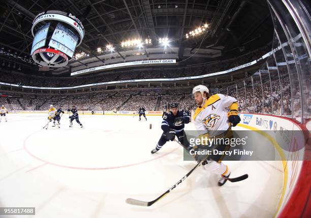 Filip Forsberg of the Nashville Predators plays the puck away from Paul Stastny of the Winnipeg Jets during second period action in Game Six of the...