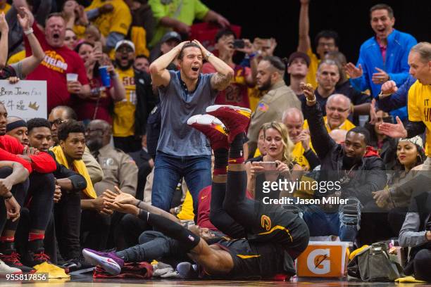 Fans react as LeBron James of the Cleveland Cavaliers tumbles to the floor after making an off-balance shot during the second half of Game 4 of the...