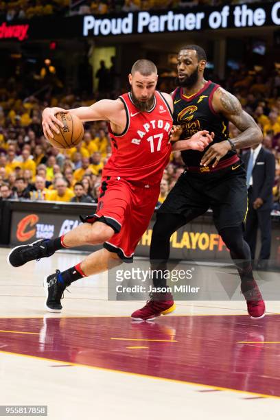 Jonas Valanciunas of the Toronto Raptors drives around LeBron James of the Cleveland Cavaliers during the first half of Game 4 of the second round of...