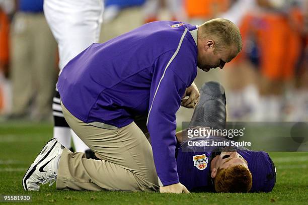 Quarterback Andy Dalton of the TCU Horned Frogs lays on the ground injured as he is getting checked on by a trainer after getting sacked against the...