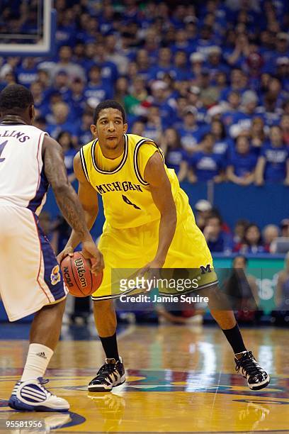 Darius Morris of the Mighigan Wolverines dribbles the ball during the game against the Kansas Jayhawks on December 19, 2009 at Allen Fieldhouse in...