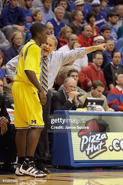 Head coach John Beilein of the Mighigan Wolverines gives instructions to Laval Lucas-Perry during the game against the Kansas Jayhawks on December...