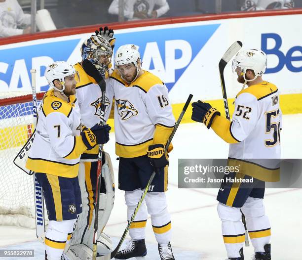 Calle Jarnkrok and Yannick Weber congratulate Pekka Rinne of the Nashville Predators after defeating the Winnipeg Jets in Game Six of the Western...