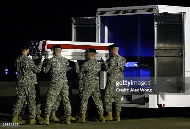 Members of a U.S. Army carry team prepare to load the flag-draped transfer case containing the remains of Army Sergeant Joshua Lengstorf of Yoncalla,...