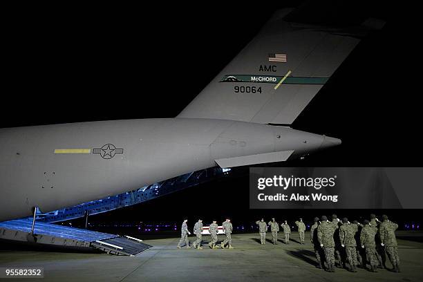 Members of a U.S. Army carry team move the flag-draped transfer case containing the remains of Army Sergeant Joshua Lengstorf of Yoncalla, Oregon,...