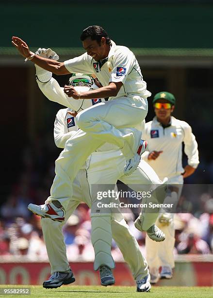 Danish Kaneria of Pakistan celebrates dismissing Phillip Hughes of Australia catching Hughes off his own delivery during the Second Test match...