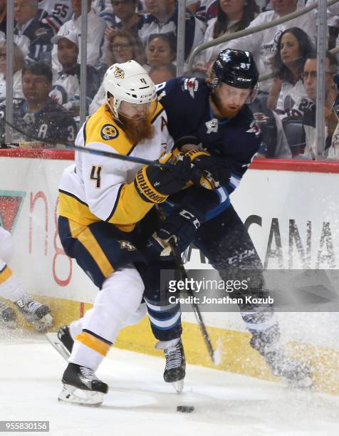 Ryan Ellis of the Nashville Predators and Kyle Connor of the Winnipeg Jets battle for the puck during third period action in Game Six of the Western...