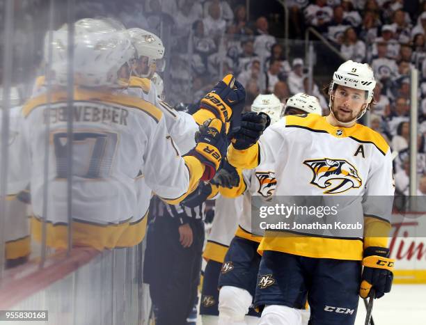 Filip Forsberg of the Nashville Predators celebrates his third period goal against the Winnipeg Jets with teammates at the bench in Game Six of the...