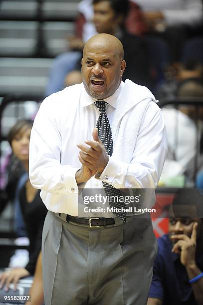 Mike Bozeman, head coach of the George Washington Colonials looks on during a women's college basketball game against the Rutgers Scarlet Knight on...