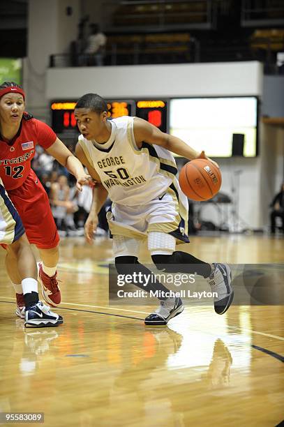 Kay-Kay Albums of the George Washington Colonials dribbles the ball during a women's college basketball game against the Rutgers Scarlet Knight on...