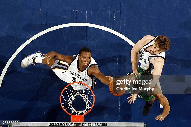 Hasheem Thabeet and Marc Gasol of the Memphis Grizzlies battle for a rebound against Rasheed Wallace of the Boston Celtics during the game at the...