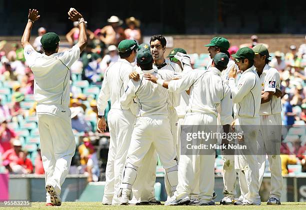 Umar Gul of Pakistan is congratulated by team mates after getting the wicket of Shane Watson of Australia during day three of the Second Test match...