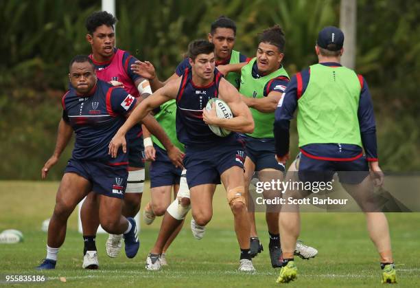 Jack Maddocks of the Rebels runs with the ball during a Melbourne Rebels Super Rugby training session at Gosch's Paddock on May 8, 2018 in Melbourne,...