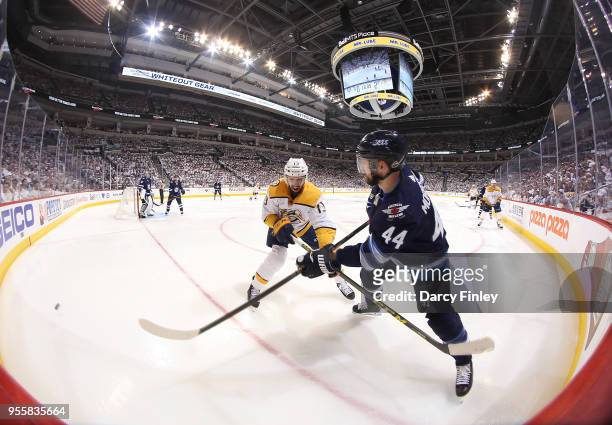 Josh Morrissey of the Winnipeg Jets shoots the puck past Nick Bonino of the Nashville Predators during third period action in Game Six of the Western...