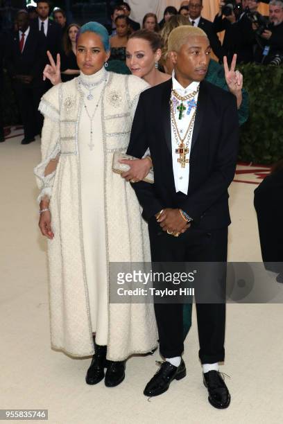 Stella McCartney photobombs Pharrell Williams and Helen Lasichanh at "Heavenly Bodies: Fashion & the Catholic Imagination", the 2018 Costume...