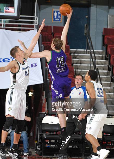 Connor Atchley of the Dakota Wizards goes to the basket against Cezary Trybanski and Desmon Farmer of the Reno Bighorns during the 2010 D-League...