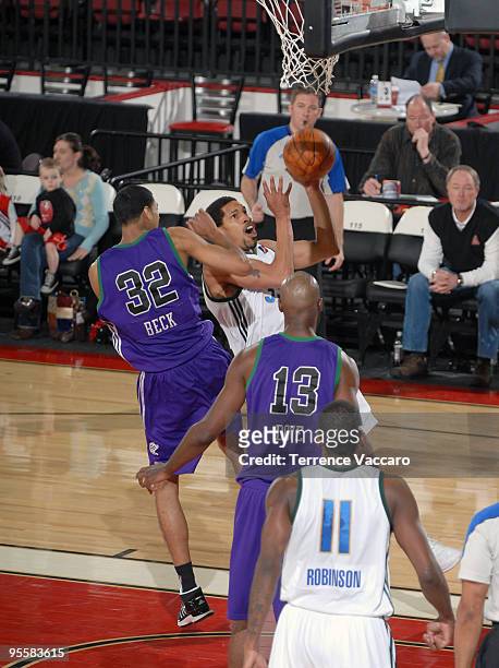 Desmon Farmer of the Reno Bighorns goes to the basket against Romel Beck and Marcus Dove of the Dakota Wizards during the 2010 D-League Showcase at...