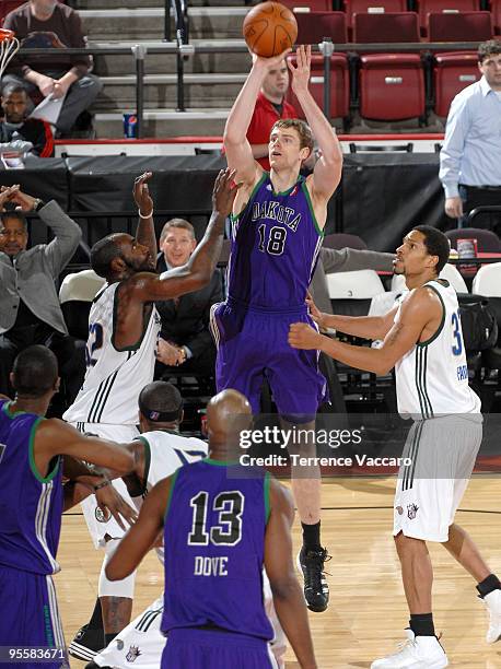 Connor Atchley of the Dakota Wizards shoots against Desmon Farmer and Doug Thomas of the Reno Bighorns during the 2010 D-League Showcase at Qwest...