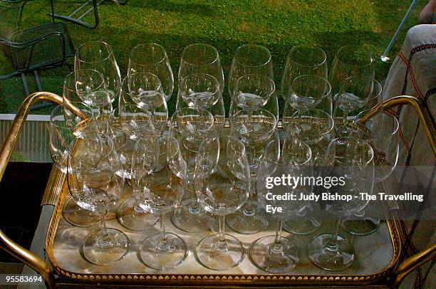 rows of crystal glasses, ready for garden party - crystal glasses stockfoto's en -beelden