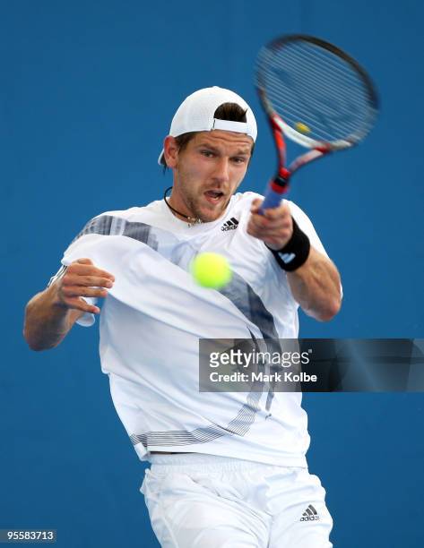 Jurgen Melzer of Austria plays a forehand during his first round match against Matthew Ebden of Australia during day three of the Brisbane...
