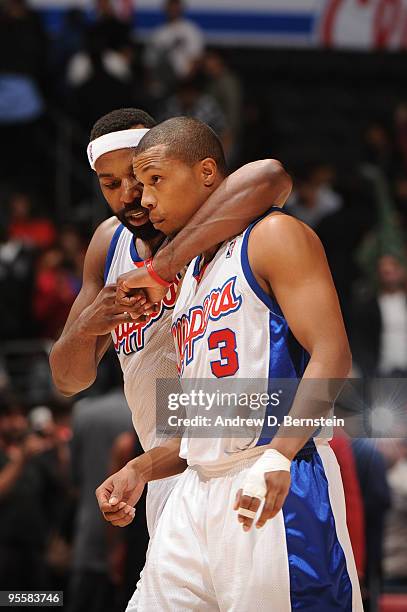 Baron Davis and Sebastial Telfair of the Los Angeles Clippers walk off the floor after defeating the Portland Trail Blazers at Staples Center on...