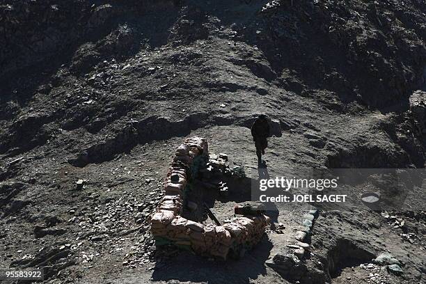 An Afghan soldier from the OMLT of the Kandak 32 is seen at a mortar position at an "Eagle's Nest" observation post in the Alah Say valley in Kapisa...