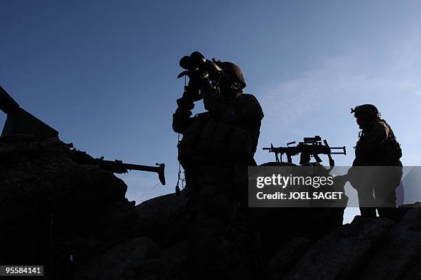 French soldiers from the OMLT of the Kandak 32 keep watch at an "Eagle's Nest" observation post in the Alah Say valley in Kapisa province on January...