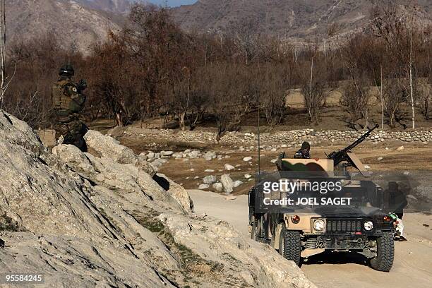 French and Afghan soldiers from the OMLT of the Kandak 32 are seen with a US-made Hummer vehicle in the Alah Say valley in Kapisa province on January...