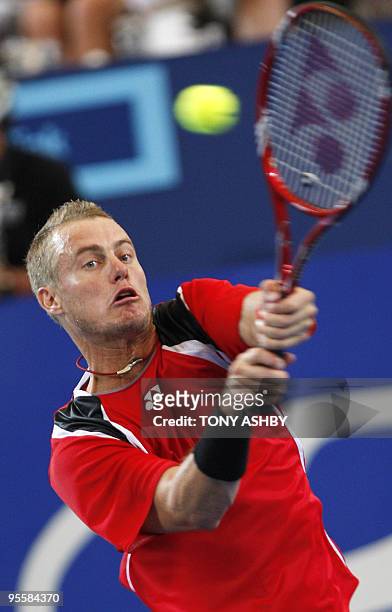 Lleyton Hewitt of Australia returns a shot against John Isner of US during their singles match on the fifth session, day four of the Hopman Cup in...