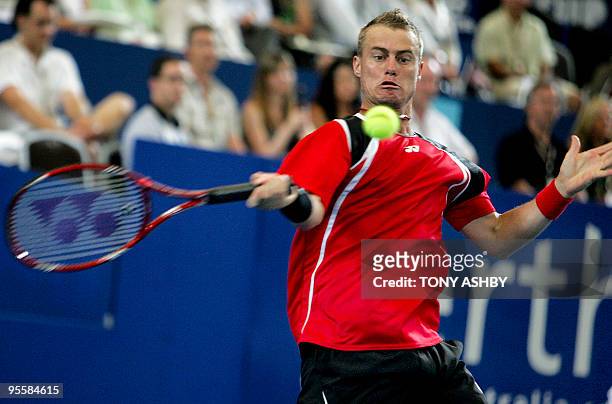 Lleyton Hewitt of Australia hits a return against John Isner of the US during their men's singles match on the fifth session of day four of the...